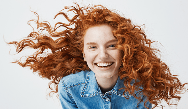 model with strawberry blonde curly hair