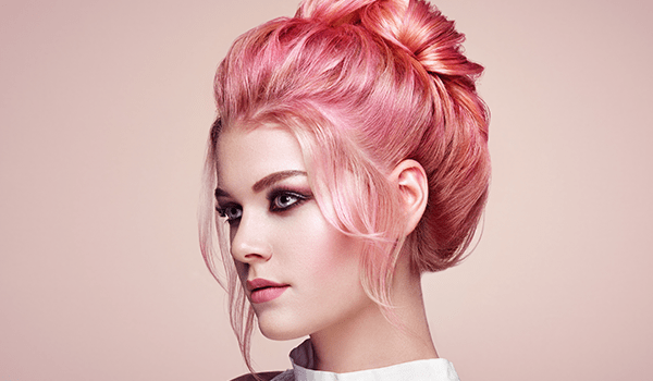 model with pink and orange faded hair put up into a bun