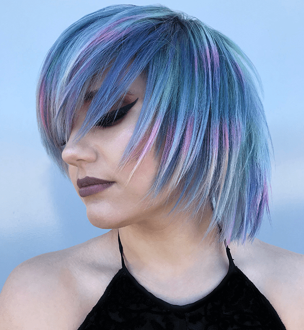 model with all over blue hair color and rainbow highlights