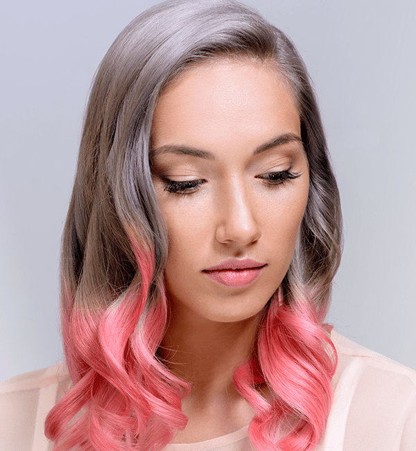 model with silver hair roots and pink tips