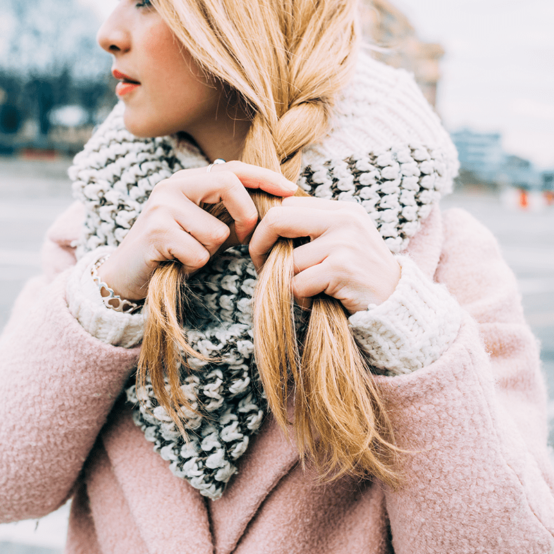 woman braiding dry, blonde hair