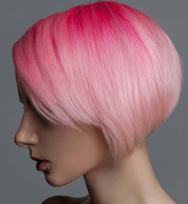 model with bright pink hair roots and pastel pink tips, cut in a bob style