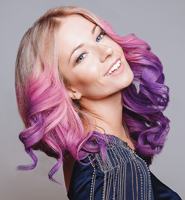 model with blonde hair, fading to pink and purple hair tips