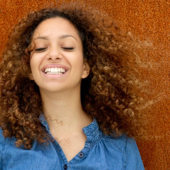 smiling woman with curly hair