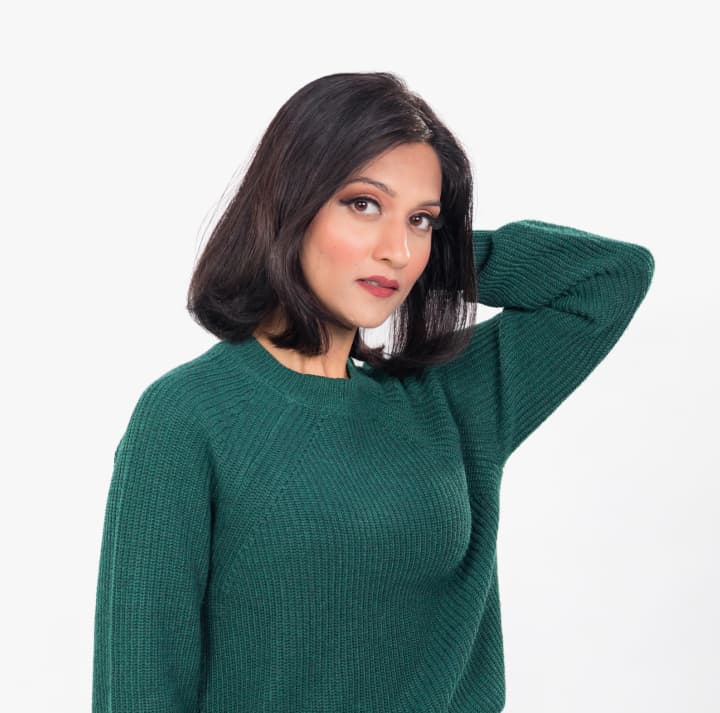 Woman with dark hair and bob haircut.