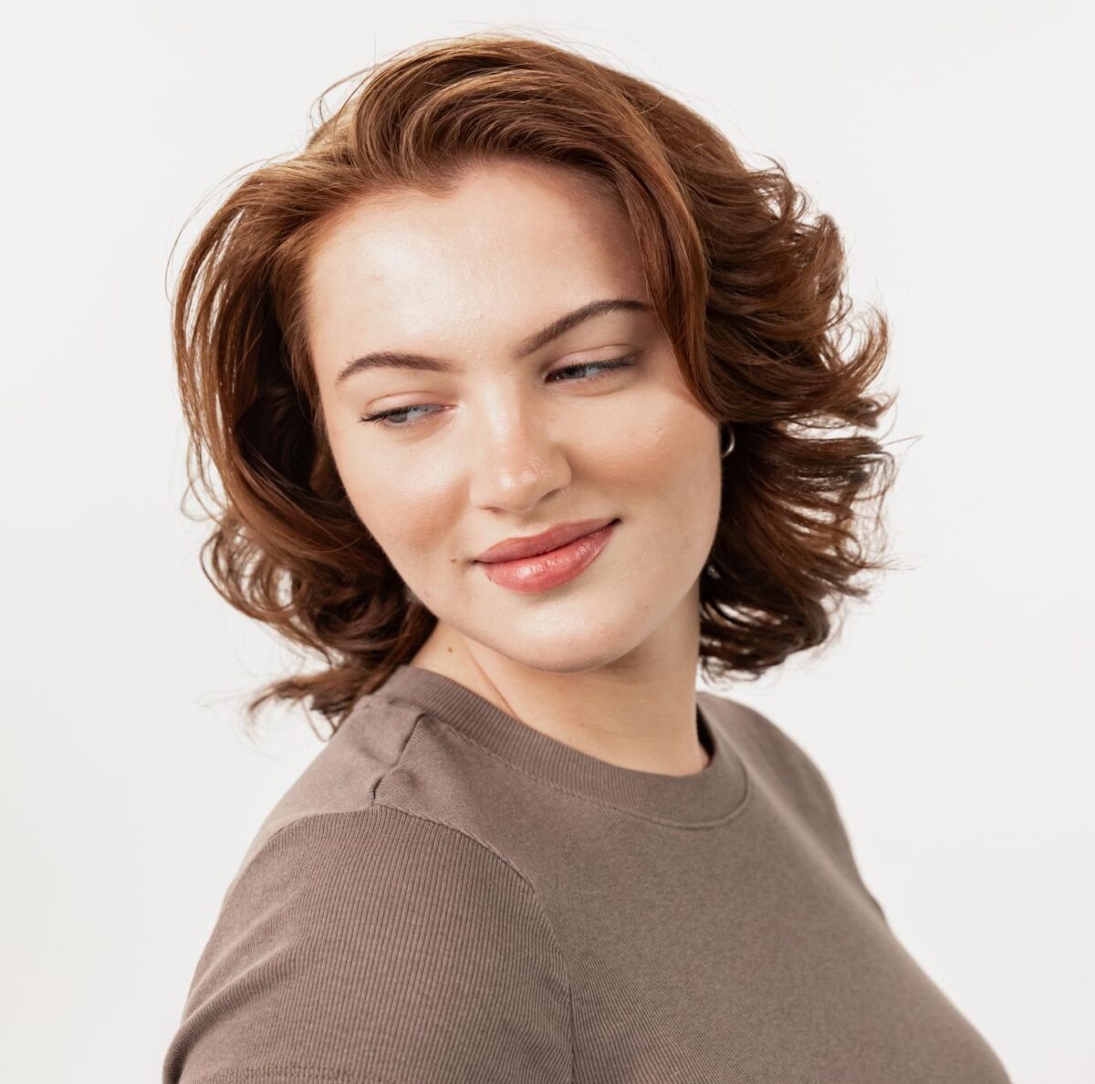 Woman showing cleanly waxed eyebrows.