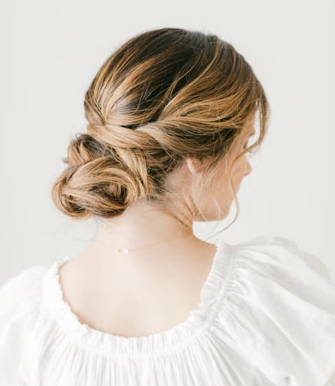 Woman shows her braided updo.